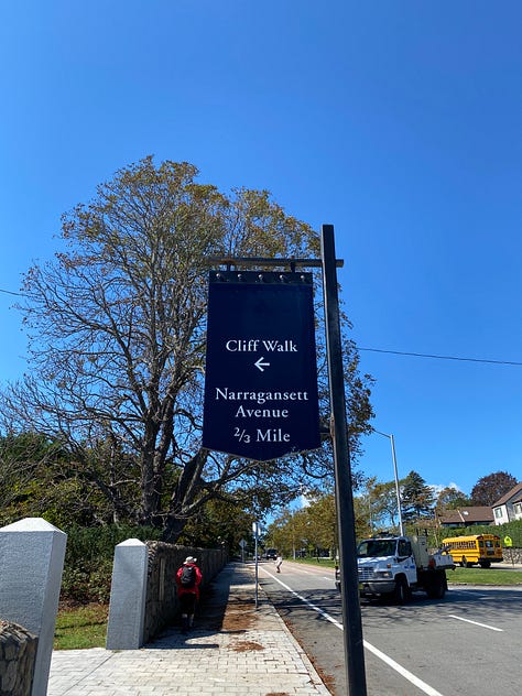 entrance, sign, ocean, trees, brush, railing, clouds