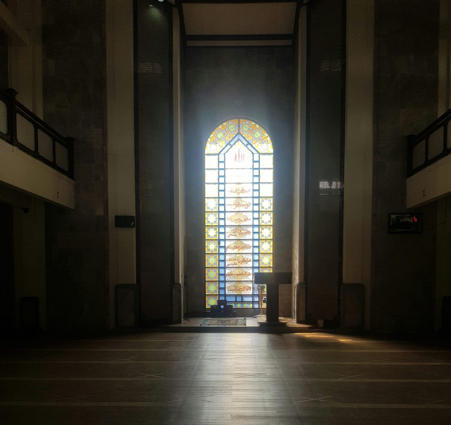 an empty church with a stained glass window