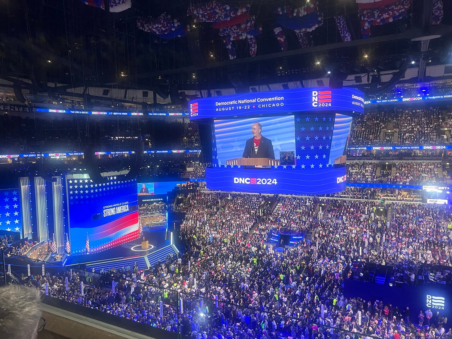 A crowded DNC with Shawn Fain on stage A crowded DNC with Shawn Fain on stage