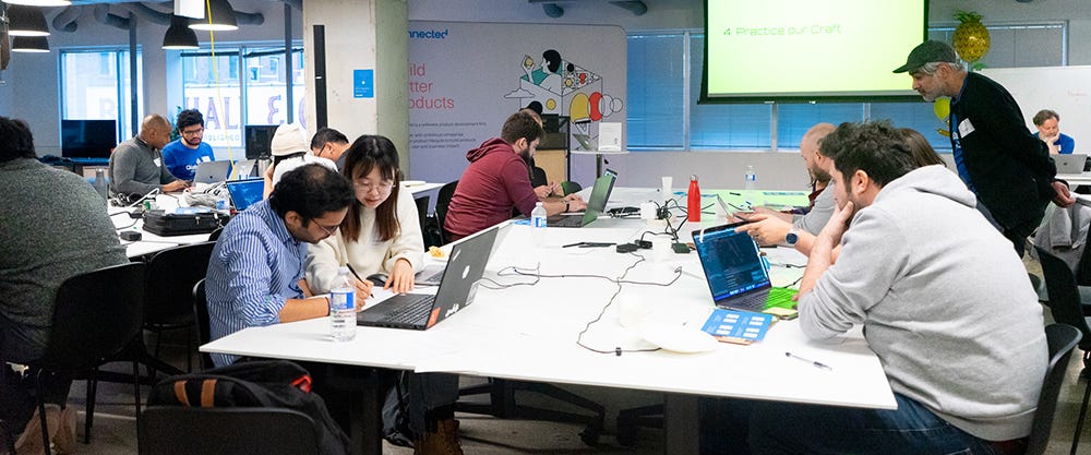 Pairs of participants deeply engrossed in problem-solving at Global Day of Coderetreat Toronto 2019.