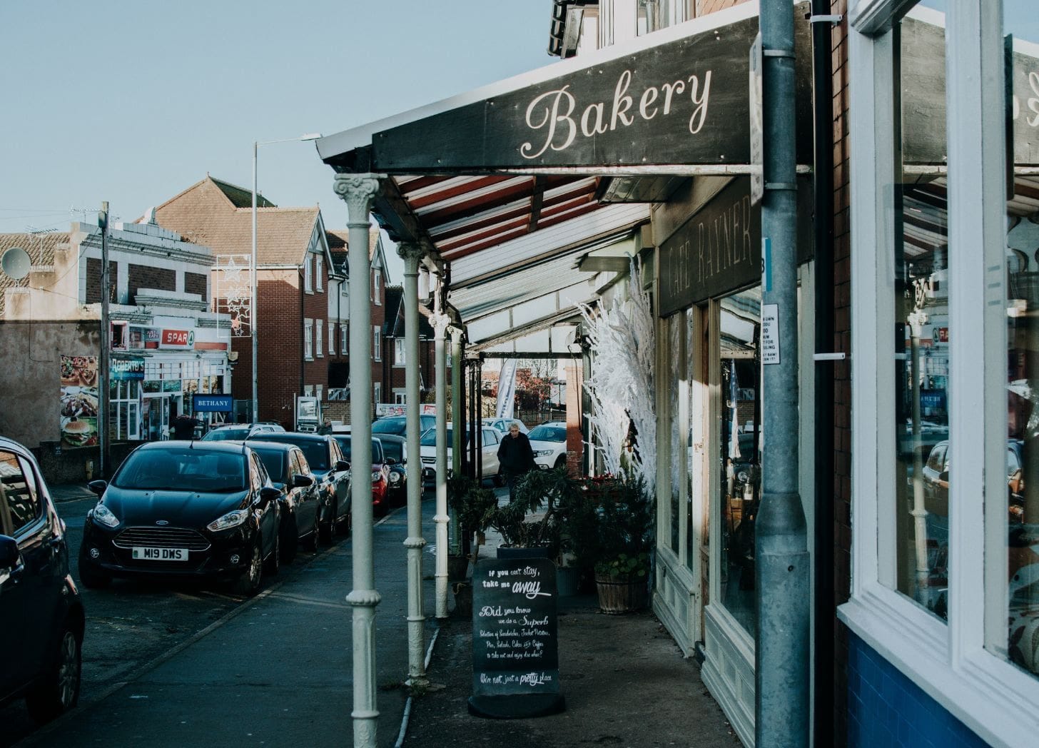 A small-town bakery storefront on Main Street, symbolizing local partnerships and neighborhood charm.