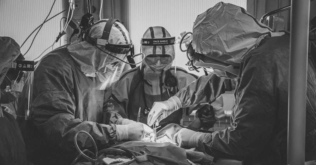 a group of doctors performing surgery in a hospital a group of doctors performing surgery in a hospital