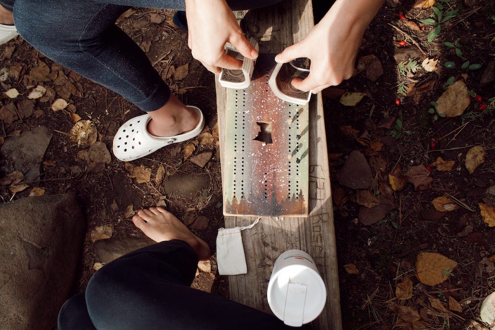 Picture shows Lisa's crocs and a cribbage board and tea mugs on a bench. Picture shows Lisa's crocs and a cribbage board and tea mugs on a bench.