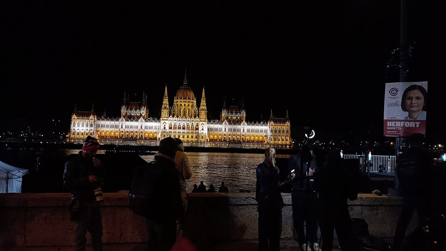 Crowd and media gather at the Tisza Party’s election-night event on Bem rakpart in Budapest on 12 April 2026.