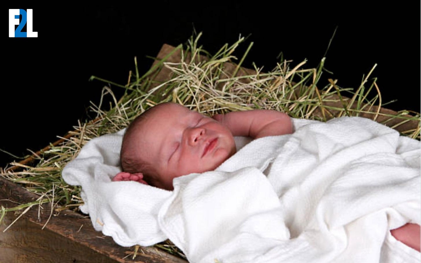 picture of a baby laying in a manger