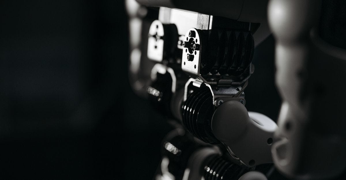Photo: Pavel Danilyuk / Pexels Detailed close-up of a robot's mechanical components, emphasized by moody studio lighting.