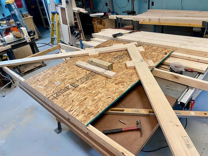 Mosaic of building greenhouse trusses and lifting them into position.
