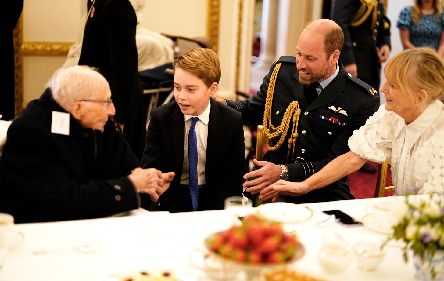 Prince George, sat with a veteran soldier shaking his hand with Prince William on the right Prince George, sat with a veteran soldier shaking his hand with Prince William on the right