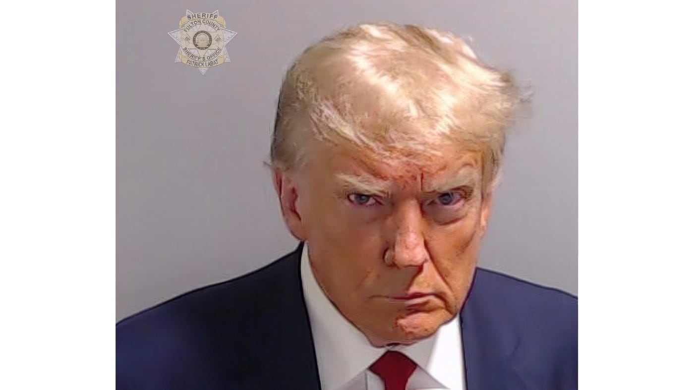 This booking photo provided by Fulton County Sheriff's Office, shows former President Donald Trump on Thursday, Aug. 24, 2023, after he surrendered and was booked at the Fulton County Jail in Atlanta. Trump is accused by District Attorney Fani Willis of scheming to subvert the will of Georgia voters in a desperate bid to keep Joe Biden out of the White House. This booking photo provided by Fulton County Sheriff's Office, shows former President Donald Trump on Thursday, Aug. 24, 2023, after he surrendered and was booked at the Fulton County Jail in Atlanta. Trump is accused by District Attorney Fani Willis of scheming to subvert the will of Georgia voters in a desperate bid to keep Joe Biden out of the White House.