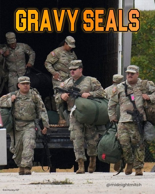Group of soldiers in camouflage uniforms and caps exit a truck trailer at an outdoor facility with chain-link fencing and trees in background, some carry rifles slung over shoulders, others hold large green duffel bags, one soldier in foreground holds a pink-strapped bag, bold orange text GRAVY SEALS SEALS overlaid at top, watermark from ABC News at bottom left. Group of soldiers in camouflage uniforms and caps exit a truck trailer at an outdoor facility with chain-link fencing and trees in background, some carry rifles slung over shoulders, others hold large green duffel bags, one soldier in foreground holds a pink-strapped bag, bold orange text GRAVY SEALS SEALS overlaid at top, watermark from ABC News at bottom left.