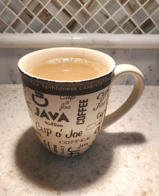 coffee in a mug sitting on a countertop