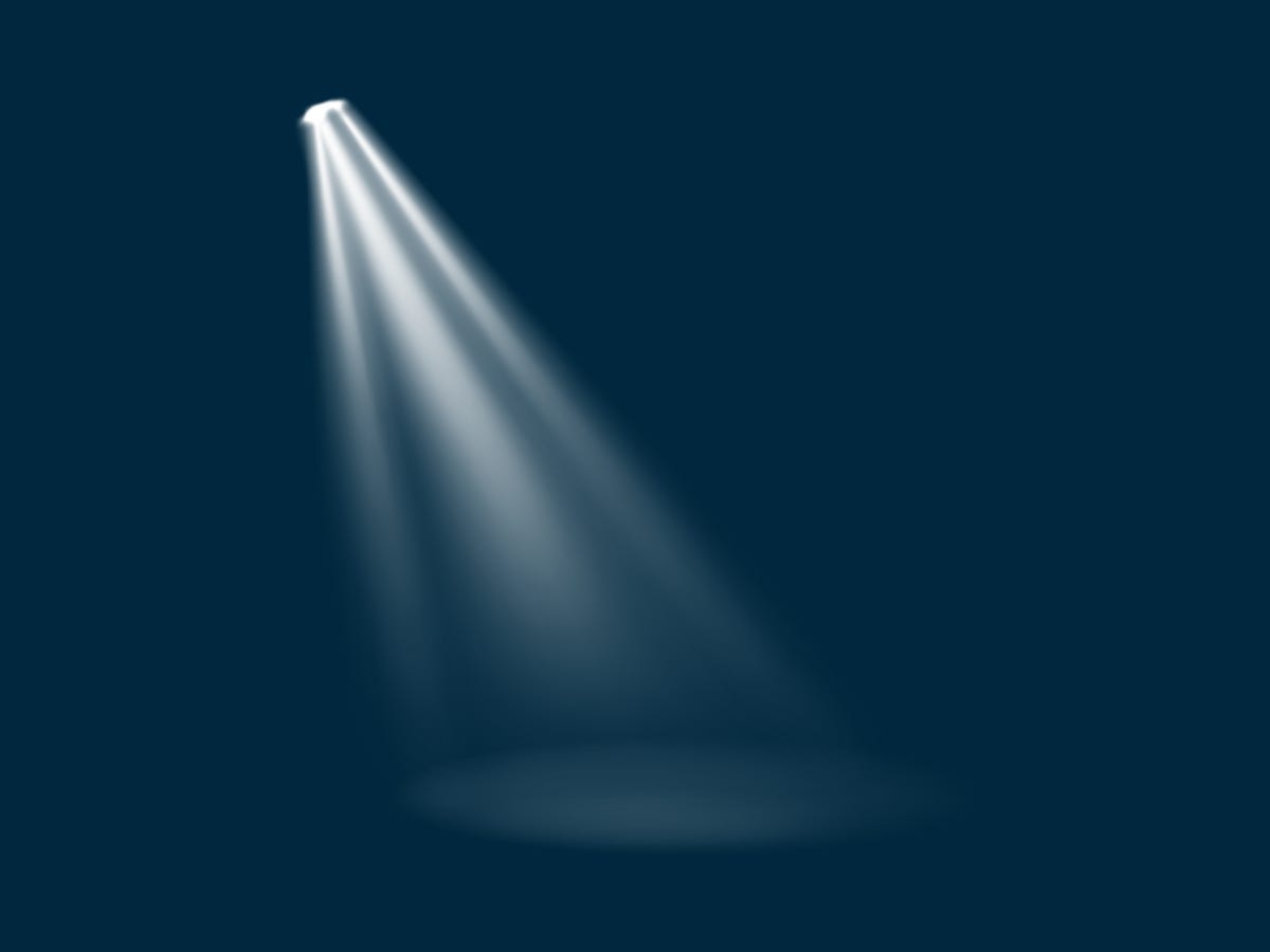 a blue background with a white spotlight in the middle