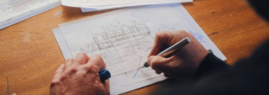 person writing on white paper person writing on white paper