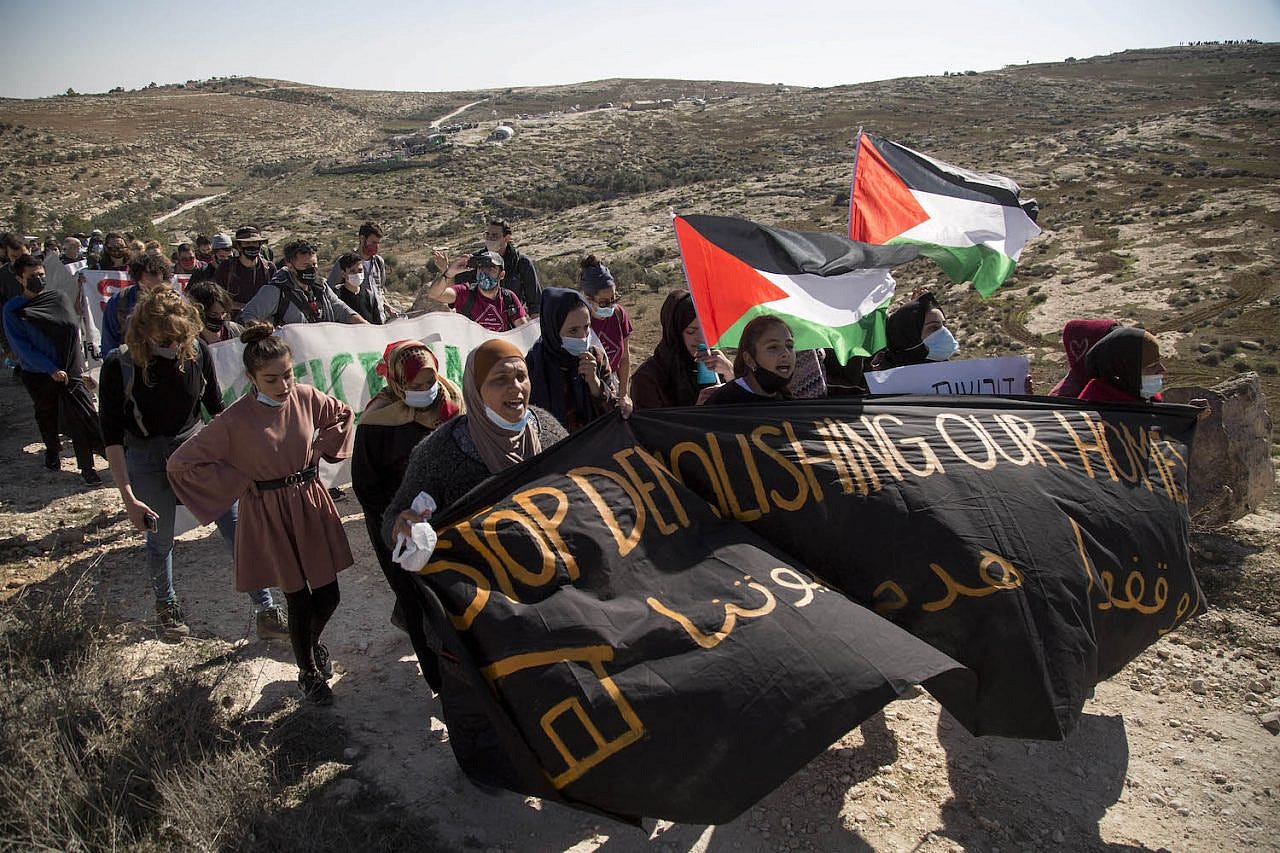 Protesters march in A-Rakeez in the Masafer Yatta region of the South Hebron Hills after Israeli soldiers shot 24-year-old Harun Abu Aram in the neck, January 8, 2021. (Keren Manor/Activestills.org) Protesters march in A-Rakeez in the Masafer Yatta region of the South Hebron Hills after Israeli soldiers shot 24-year-old Harun Abu Aram in the neck, January 8, 2021. (Keren Manor/Activestills.org)