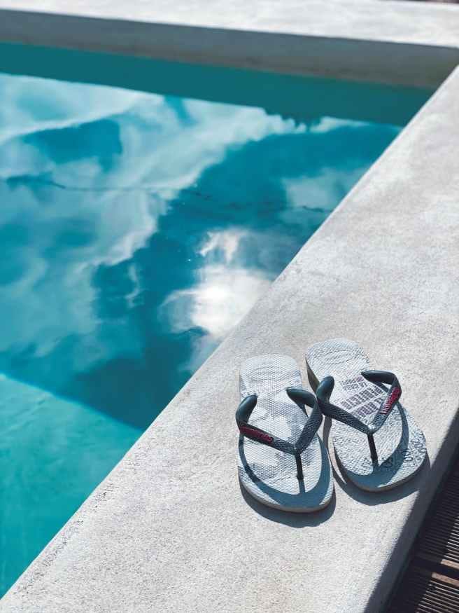 gray and black sandals on gray concrete surface gray and black sandals on gray concrete surface