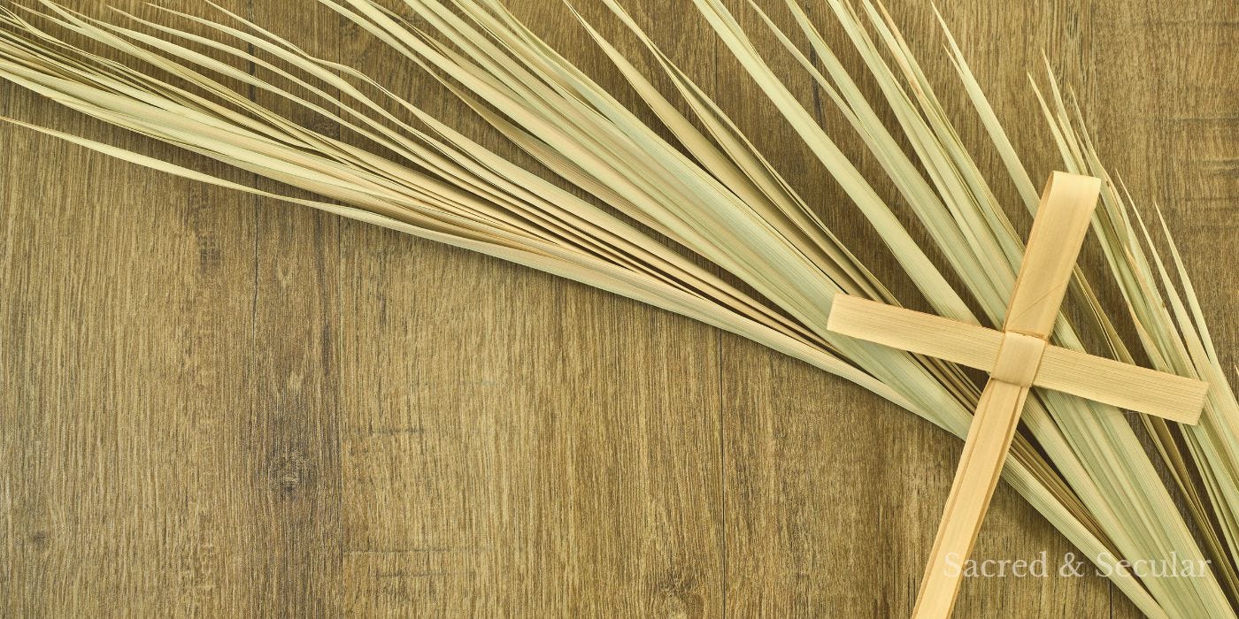 A palm cross and branch on a wooden background A palm cross and branch on a wooden background