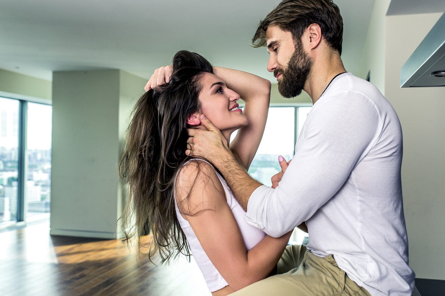 A lusty couple flirts and pull one another close.