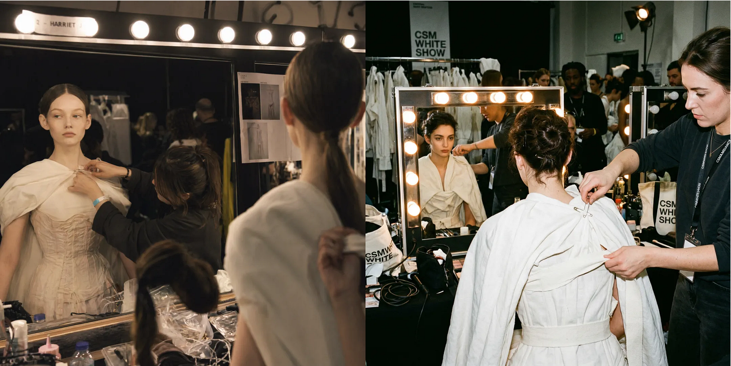 Prompt Example: Simulate a candid shot taken backstage at the Central Saint Martins White Show: Lights are illuminated in the dressing room mirror; a stylist is tightening a corset and pinning a cape onto a model with a beautiful face. Requirements: Accurate hand and physical interaction; realistic tension between pins and fabric; reasonable mirror reflection; composition should use the reflection in the mirror to create a secondary image. Prompt Example: Simulate a candid shot taken backstage at the Central Saint Martins White Show: Lights are illuminated in the dressing room mirror; a stylist is tightening a corset and pinning a cape onto a model with a beautiful face. Requirements: Accurate hand and physical interaction; realistic tension between pins and fabric; reasonable mirror reflection; composition should use the reflection in the mirror to create a secondary image.