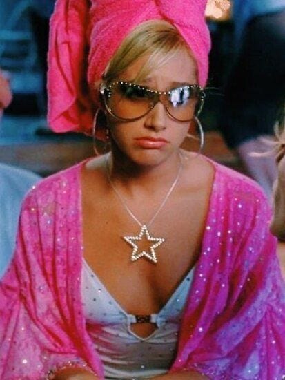 This may contain: a woman wearing sunglasses and a pink scarf around her head with a star on it This may contain: a woman wearing sunglasses and a pink scarf around her head with a star on it