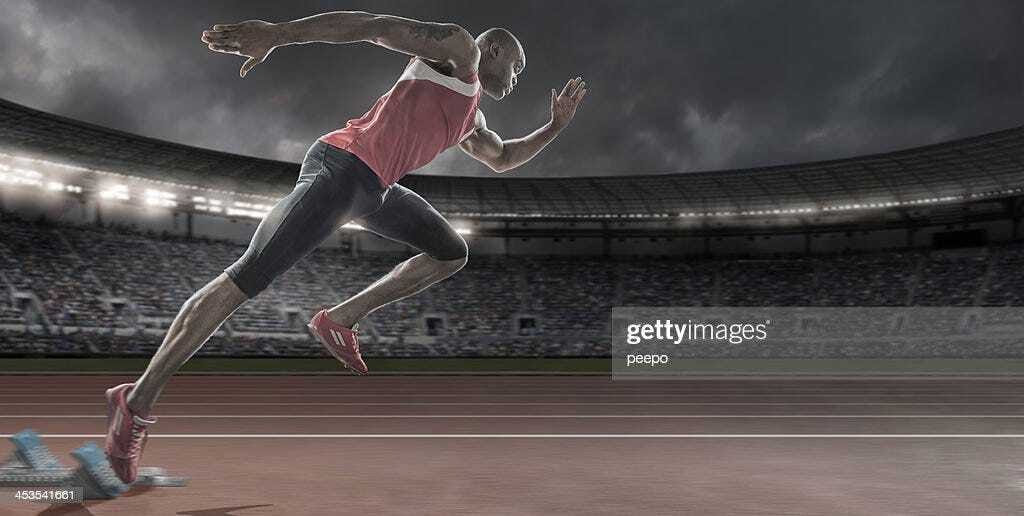 Sprinter in Mid Flow Bursting Out Of Starting Blocks Sprinter in Mid Flow Bursting Out Of Starting Blocks