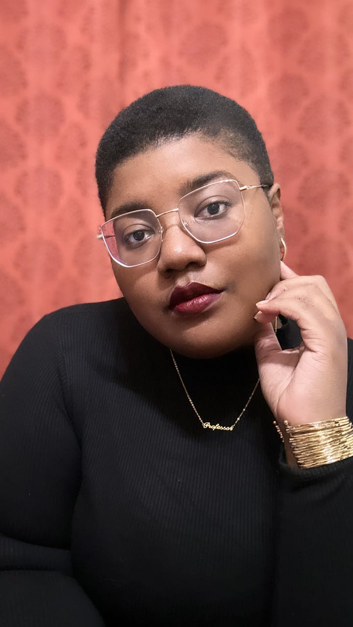 Image 1: Ravynn leans forward wearing a lavender blazer over an all black outfit. Image 2: medium close up of Ravynn in a black turtle neck, gold jewelry, gold glasses and a wine colored lipstick in front of a burnt orange background.