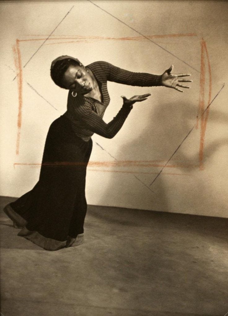 This may contain: an old photo of a woman dancing
