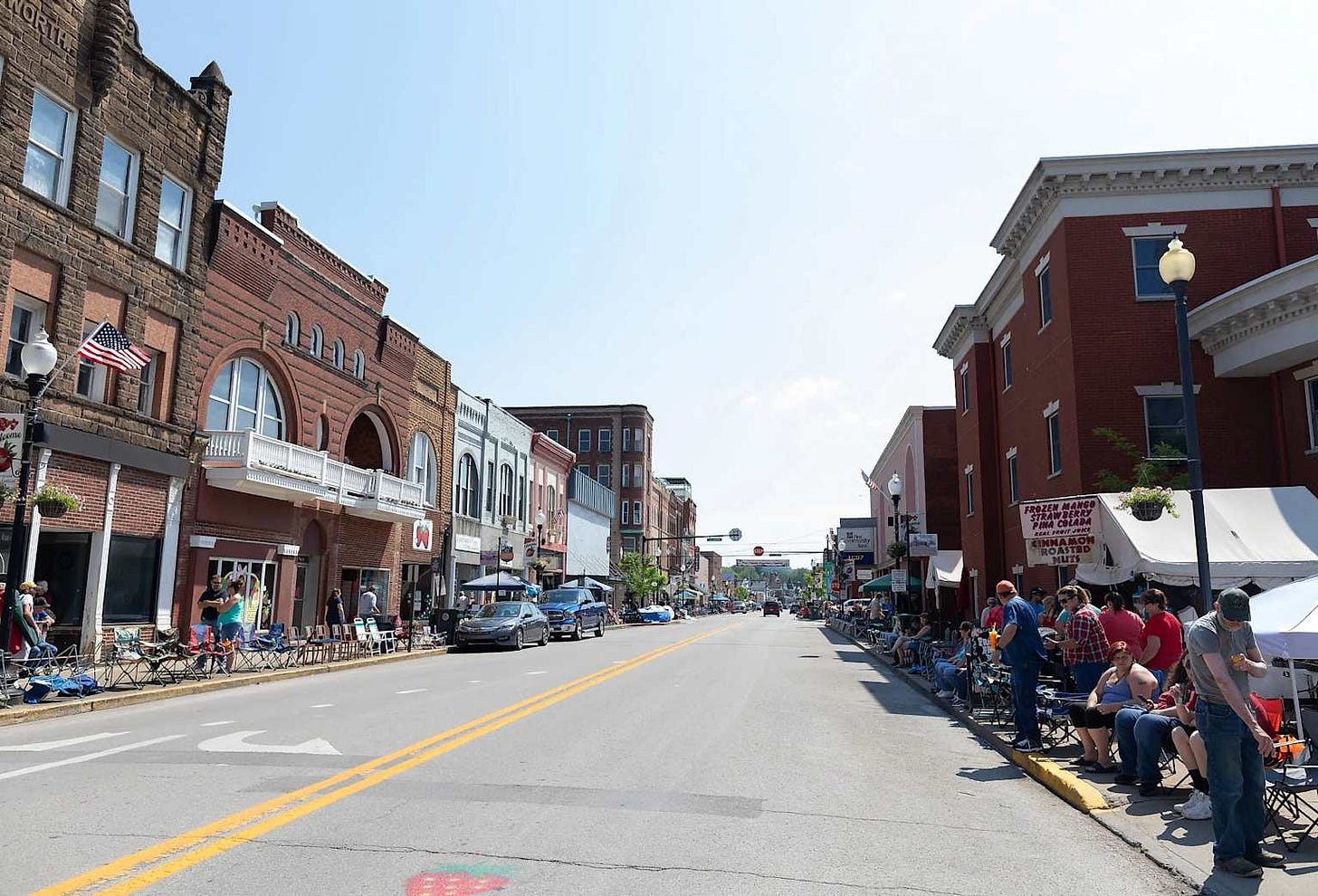 A bustling main street in a West Virginia small town with local businesses and community activity
