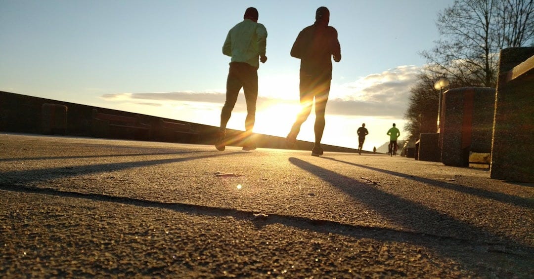two men running at park