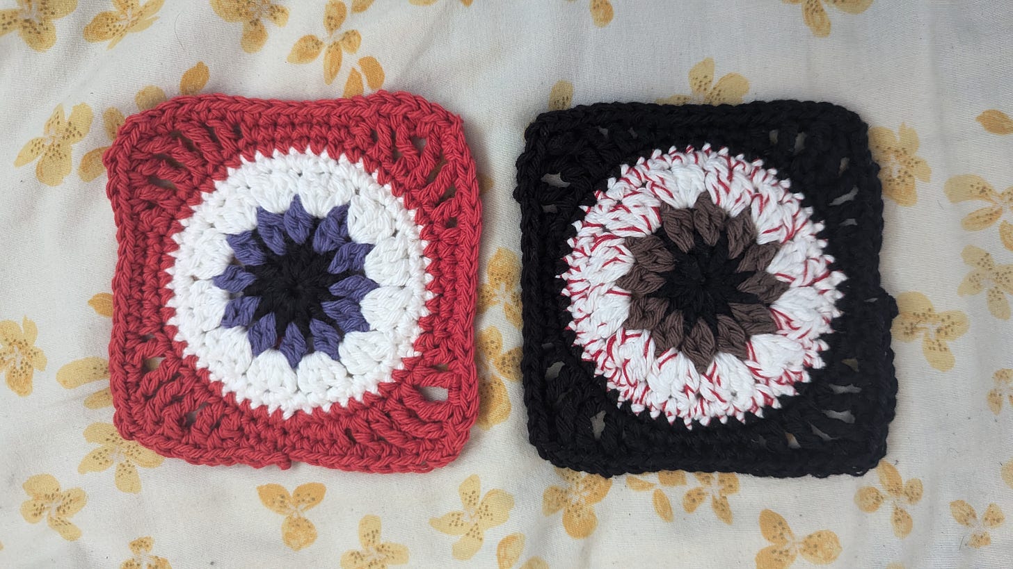 Two crocheted granny squares; both are an eyeball with a solid color border. One has a purple iris and a red border, and the other has a brown iris and a black border. The second eyeball was made to look bloodshot with red yarn.