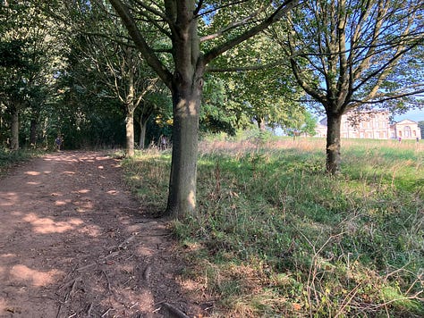 Paths then a field heading up to the hall