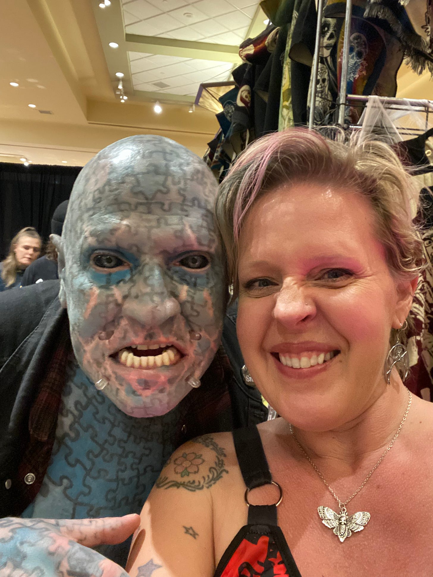 man with puzzle tattoos and a blonde woman