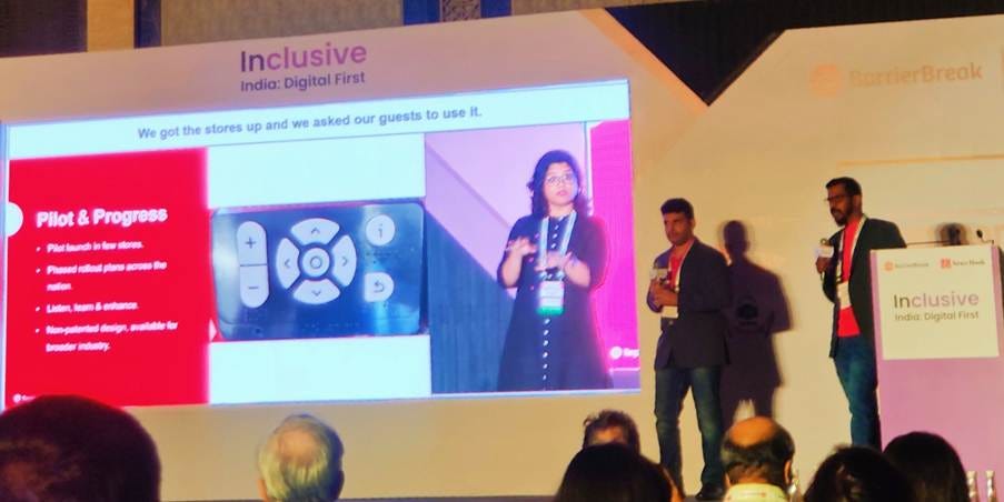 Rajath T and Senthilkumar S from Target walking a room full of audience through their accessible self-checkout kiosk in a PowerPoint presentation, at the Inclusive India Digital First Conference Rajath T and Senthilkumar S from Target walking a room full of audience through their accessible self-checkout kiosk in a PowerPoint presentation, at the Inclusive India Digital First Conference