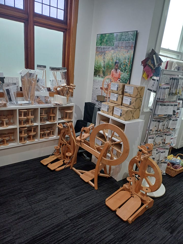 1: A horizontal loom in the foreground; skeins of coloured yarn in the background. 2: Several kinds of spinning wheel and some machines I think meant to turn skeins into balls of yarn?