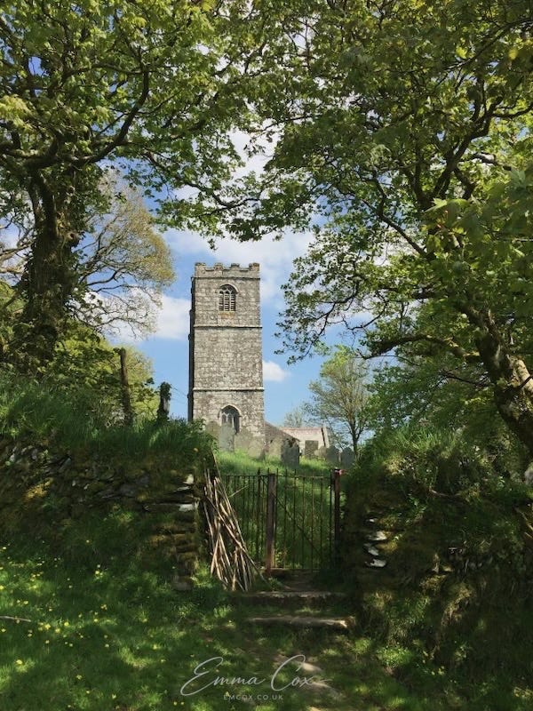 An English church framed by trees.