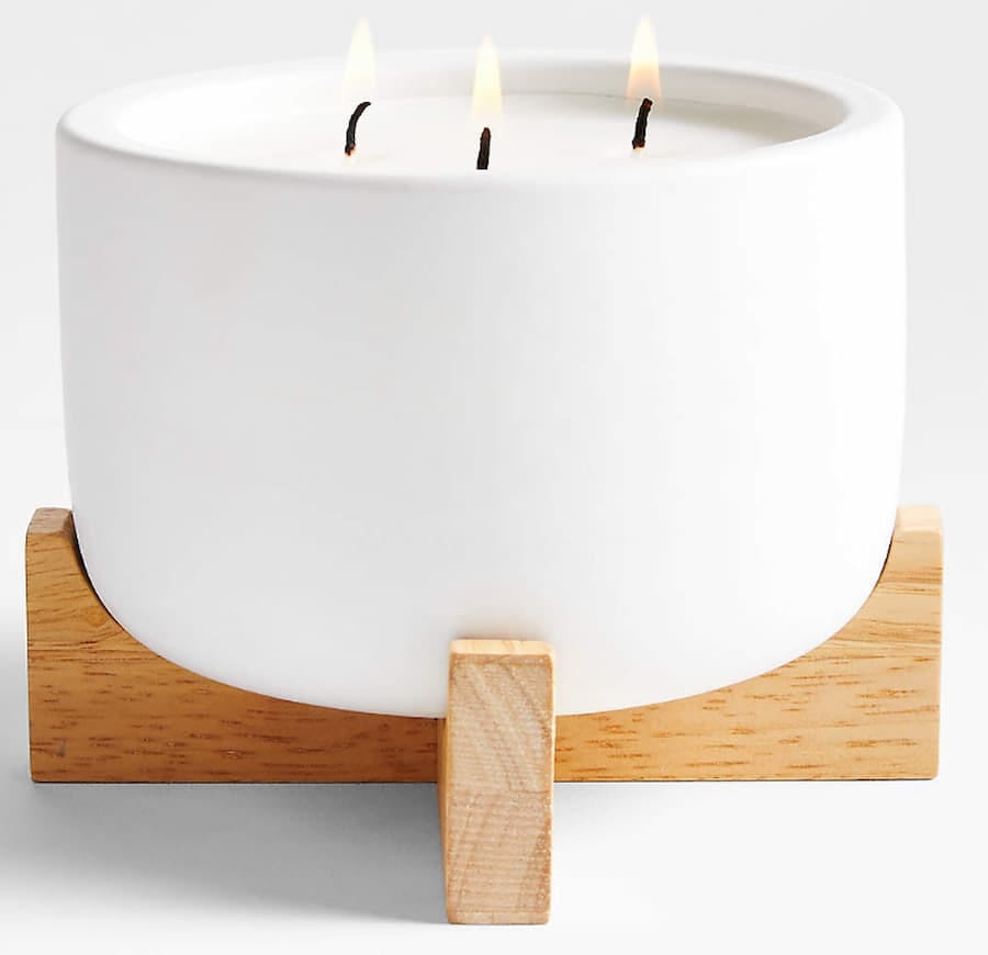 white candle with wooden stand
