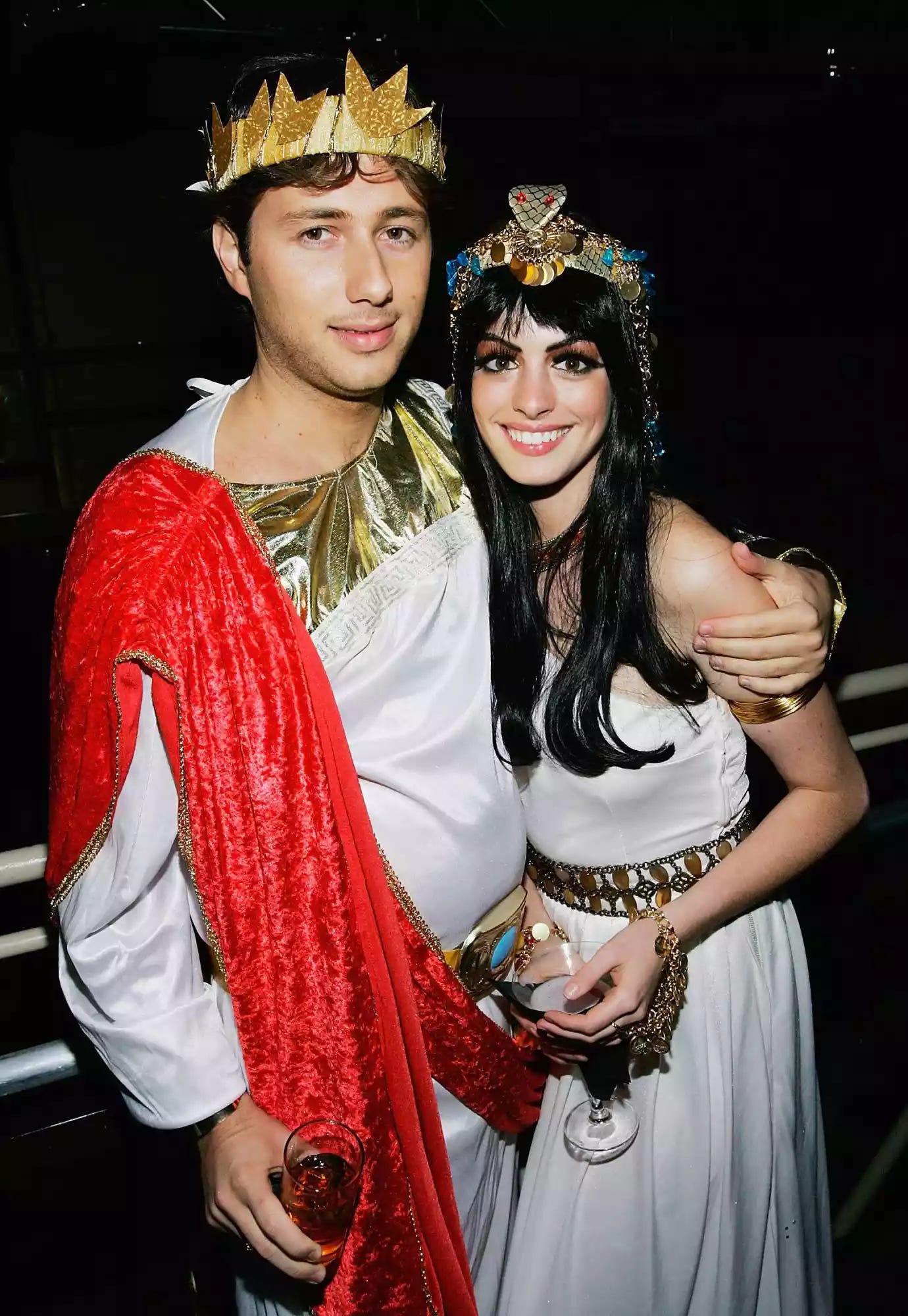 Anne Hathaway wearing a Cleopatra costume with Raffaello Follieri, who is wearing a coordinating Egyptian pharaoh costume