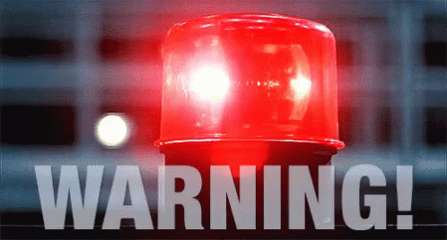 a red warning light is lit up in front of a building a red warning light is lit up in front of a building