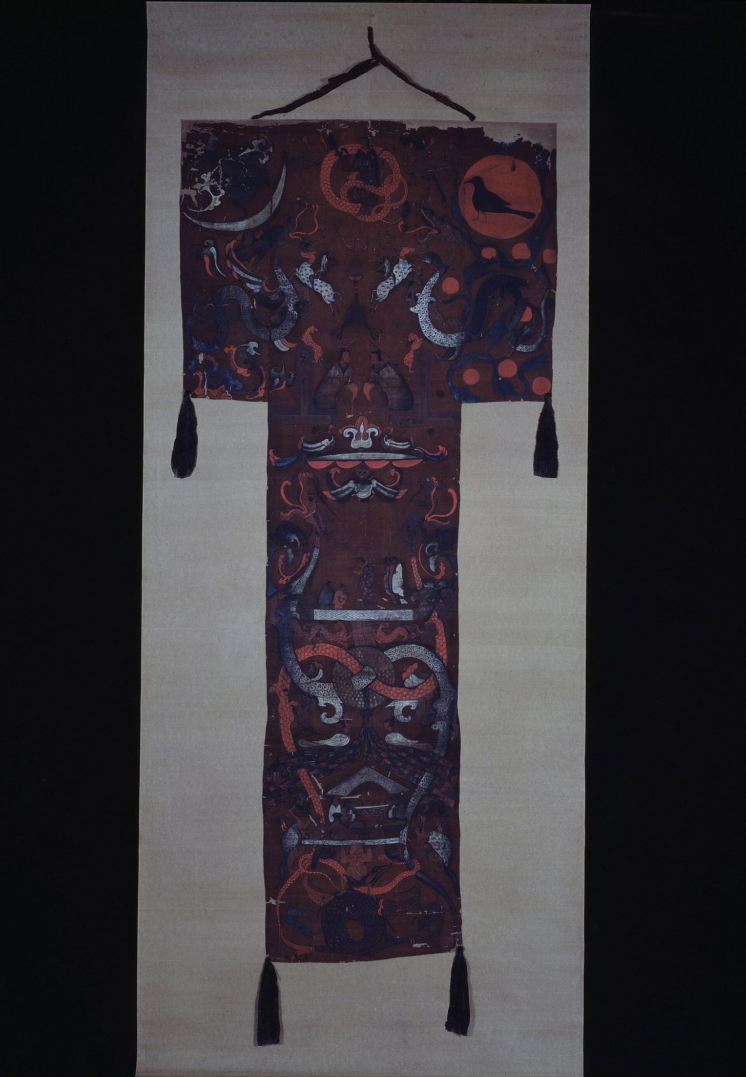 A T-shaped painted silk banner from the tomb of Lady Dai, laid out with tassels at its lower corners A T-shaped painted silk banner from the tomb of Lady Dai, laid out with tassels at its lower corners