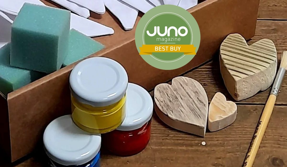 Fabric Bunting Experience Box - shown is an open box on a wooden table, inside the box is plain bunting and some sponge cubes, next to some paint jars, wood blocks in heart shapes, and a paintbrush