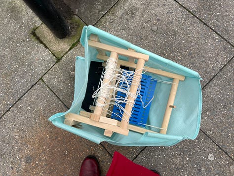 loom in trash and then being used to weave a striped textile