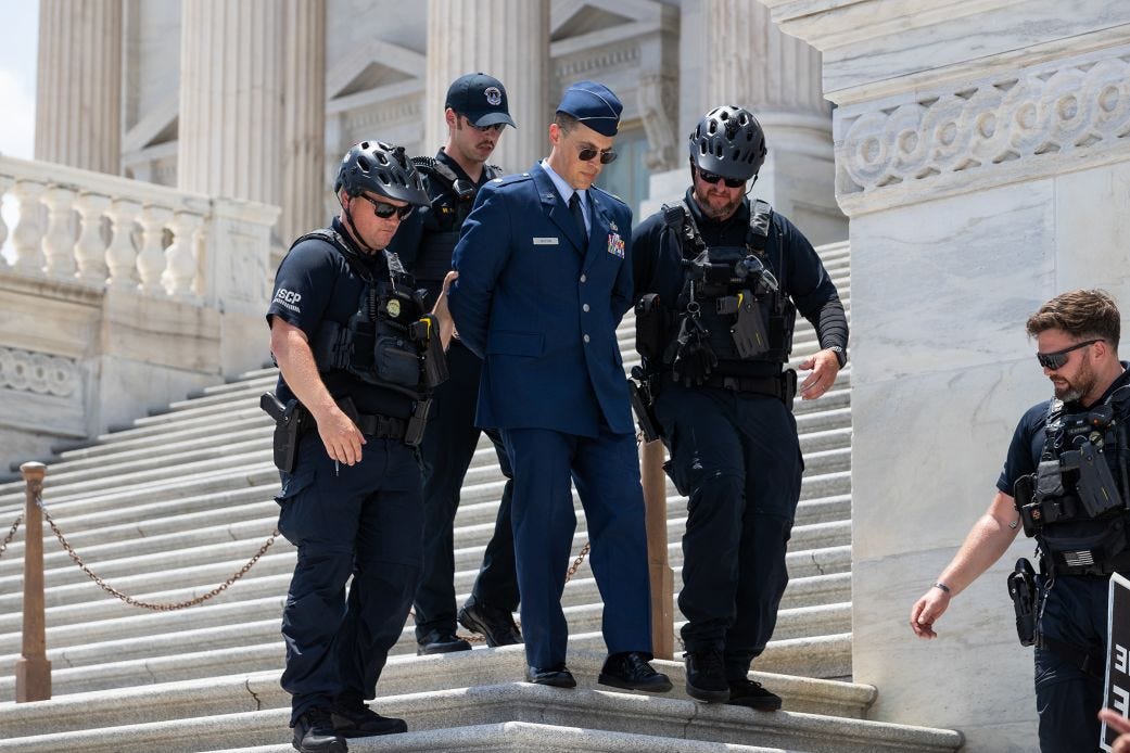 Air Force Major Jason Watson is arrested by police on the steps of the US Capitol on Wednesday, after calling for the impeachment and removal of President Donald Trump. Air Force Major Jason Watson is arrested by police on the steps of the US Capitol on Wednesday, after calling for the impeachment and removal of President Donald Trump.