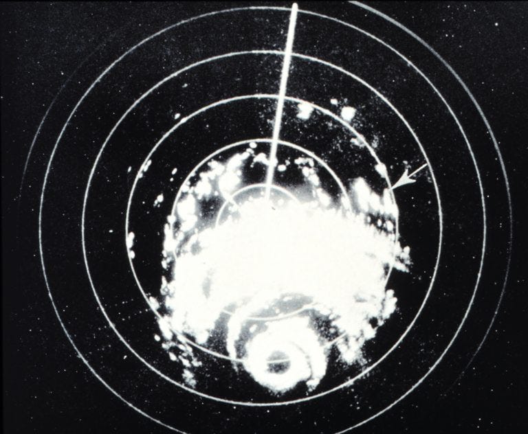 black and white grainy image with concentric circles and a horizontal white line.. white splotches look like a hurricane black and white grainy image with concentric circles and a horizontal white line.. white splotches look like a hurricane