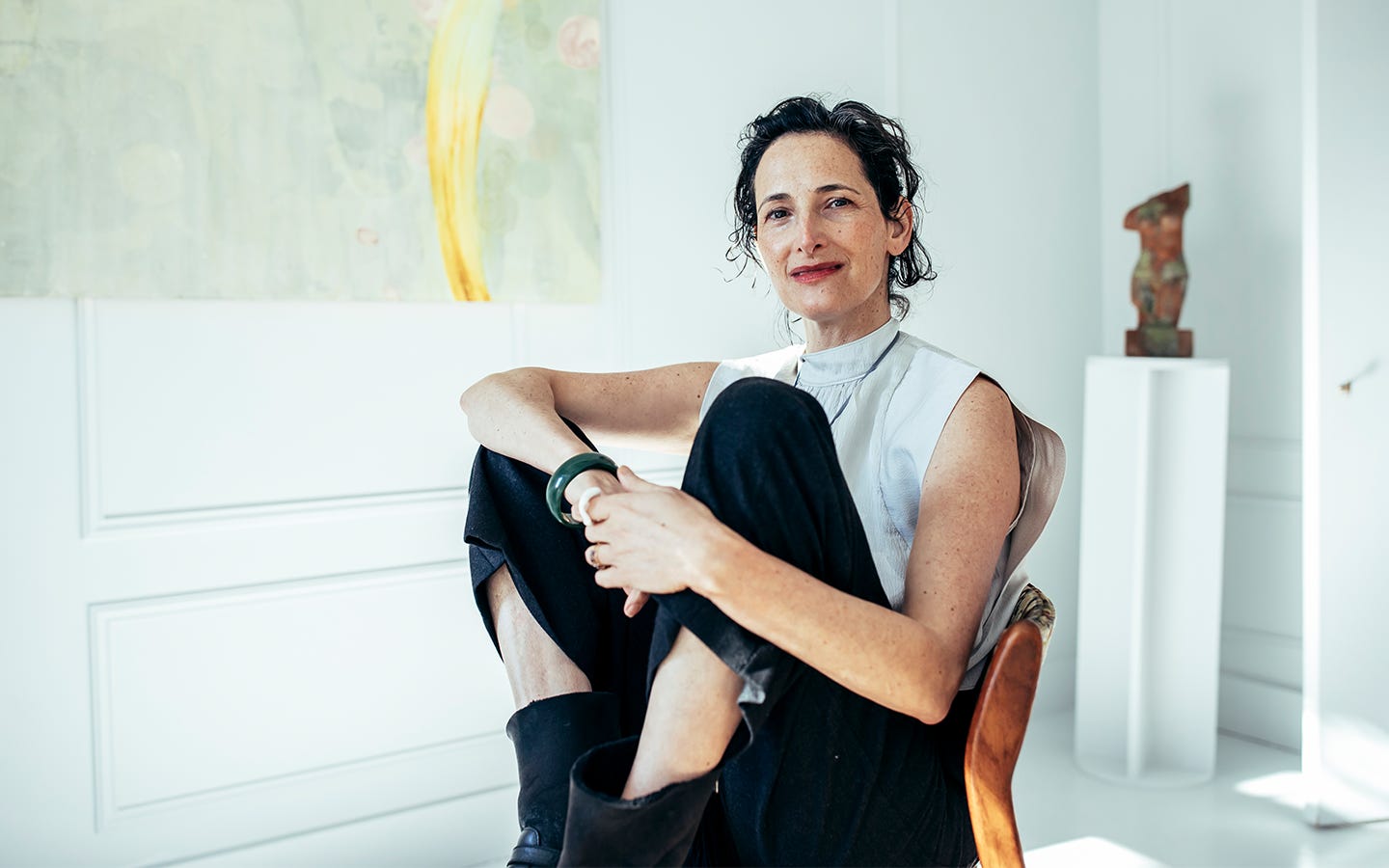 Dr. Catherine sitting in a beautiful studio