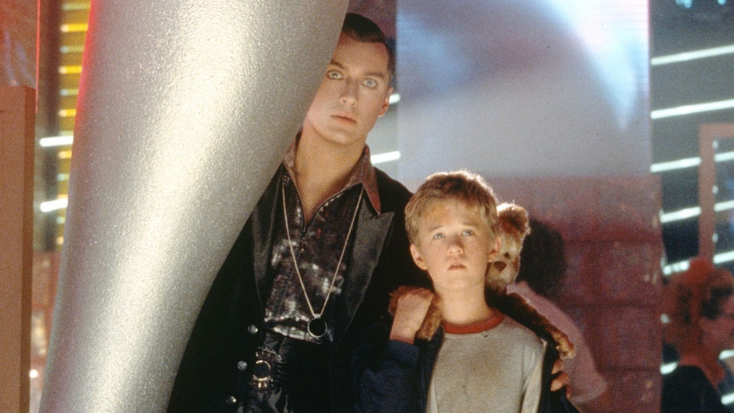 A.I. Artificial Intelligence | Still features Jude Law as Gigolo Joe and Haley Joel Osment as David venturing through a futuristic city.