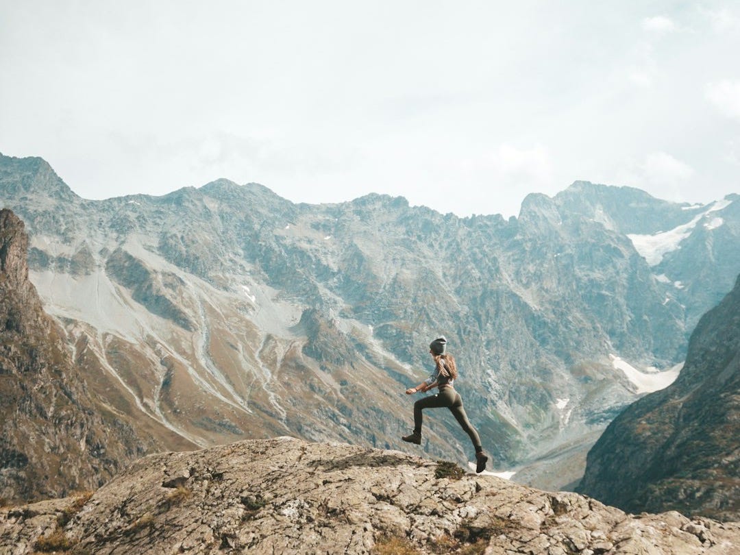 person standing on mountain scenery