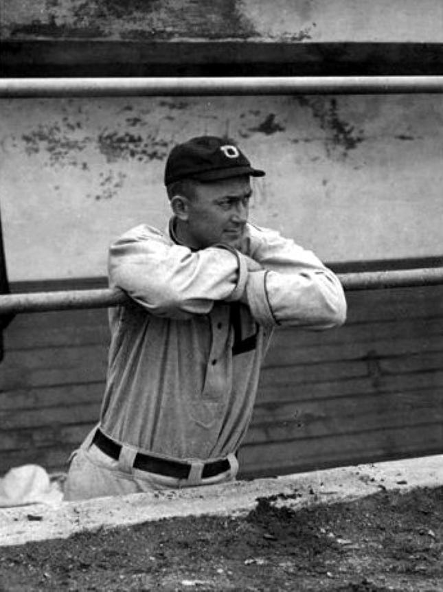 A flint-eyed Ty Cobb watches a game from the dugout rail. A flint-eyed Ty Cobb watches a game from the dugout rail.