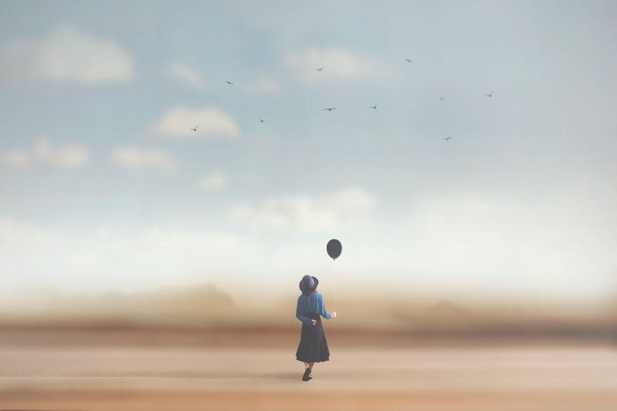 Woman on Beach Holding a Balloon