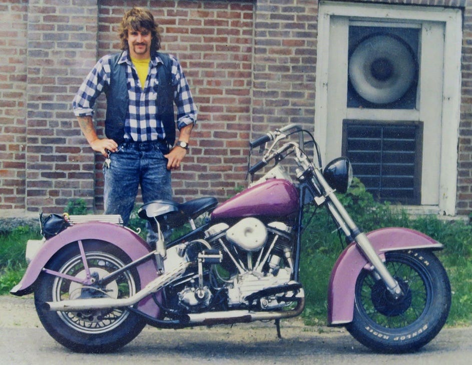 A person standing next to a motorcycle
Description automatically generated A person standing next to a motorcycle
Description automatically generated