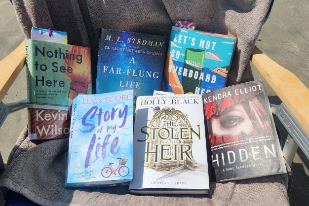 6 hardcover books on a beach chair