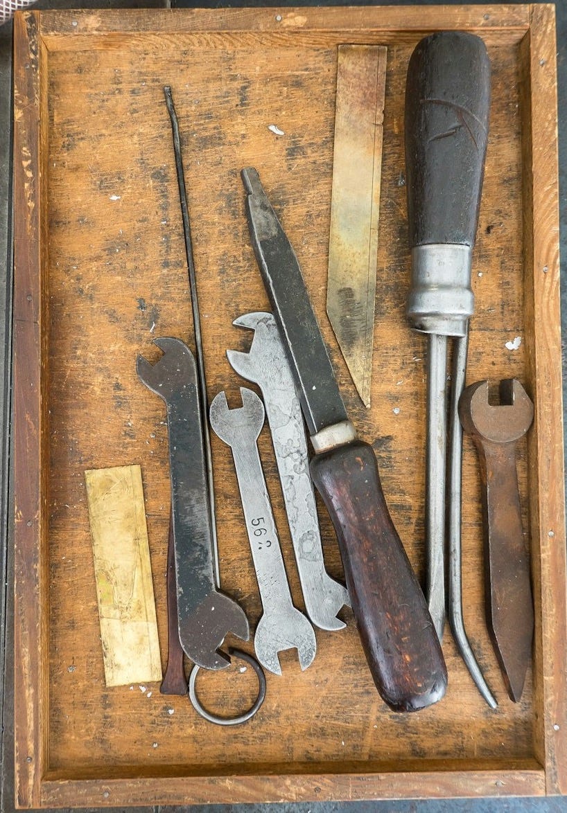 assorted-color mechanical tools on wooden tray